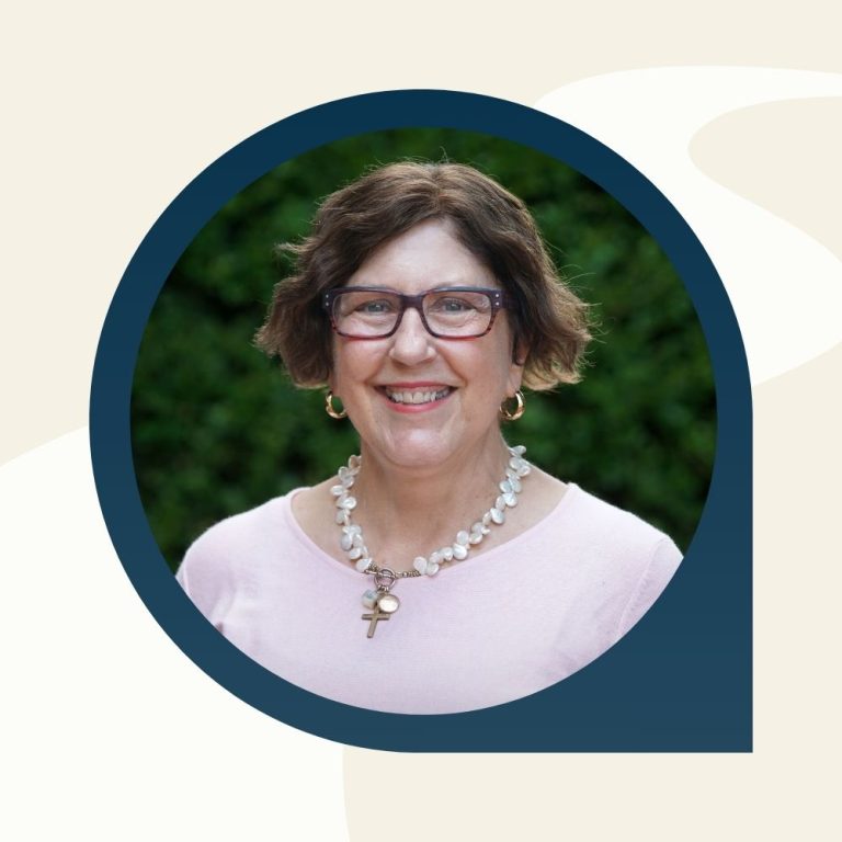 headshot of Gina smiling outside.